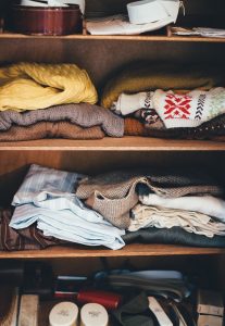 Some clothes packed on shelves.