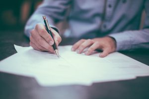 A man signing a contract.