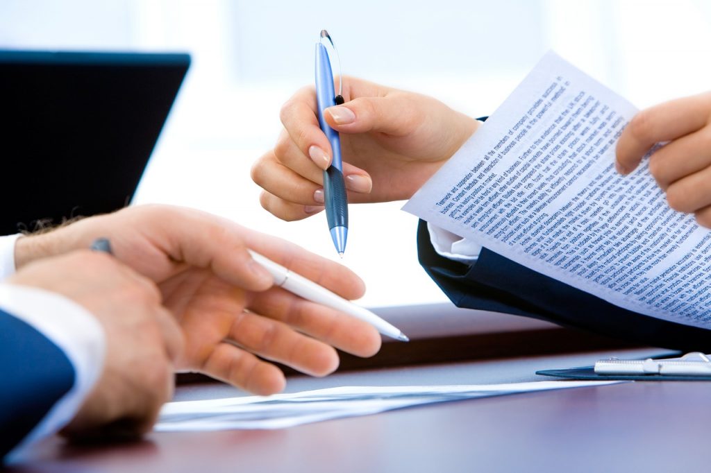 A person dealing with paperwork in order to find an apartment for rent in Hong Kong
