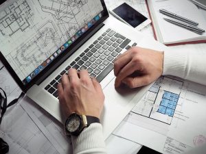 A man looking at blueprints before moving to a smaller Florida apartment