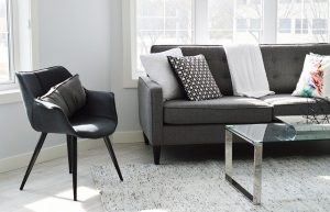 Dark-colored furniture ina living room.
