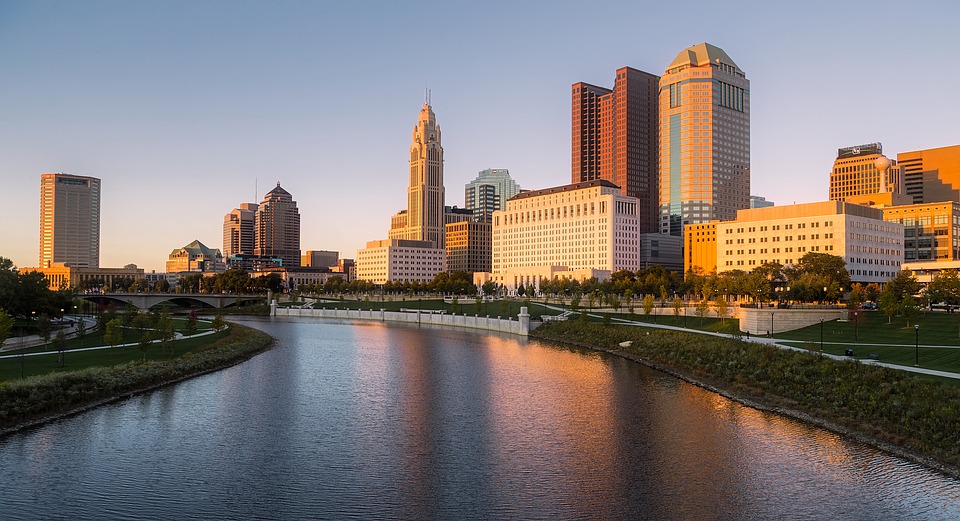 Buying a house in Columbus remotely will save you a lot of time. Here is all you need to know. Alt text: view of the river in downtown Columbus, Ohio.