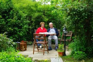 An older couple sitting at the garden table and relaxing.