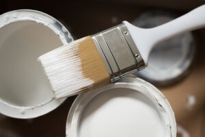 A paintbrush and paint cans. 