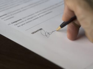 A person signing a document.