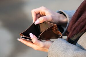 A person holding an empty wallet