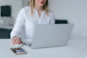 A woman doing research on her laptop to find out more about buying a family house in Crofton.