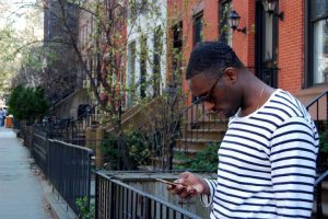 A man in a Brooklyn neighborhood.